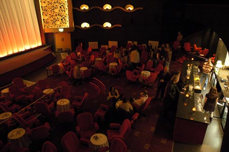 cabaret tables with glow of the bar to the right